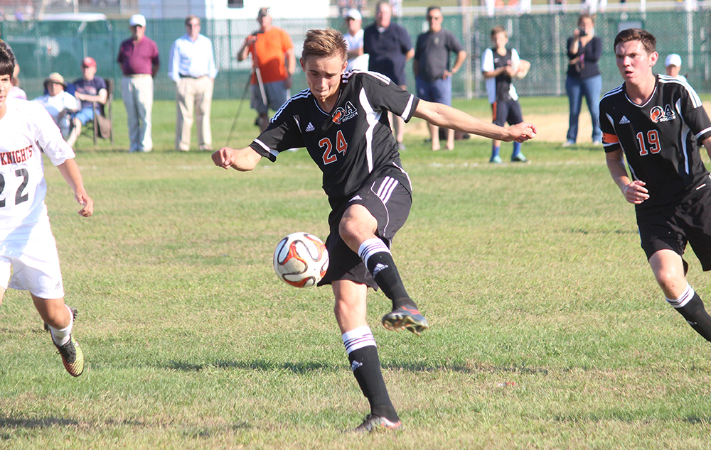 Oliver Ames' Cam Vella clears the ball in the first half against Stoughton. (Ryan Lanigan/HockomockSports.com)