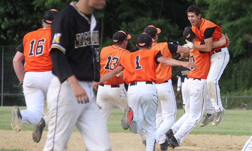 Stoughton players rush to celebrate with Pat Hagerty (far right) after driving the winning run in. (Ryan Lanigan/HockomockSports.com)